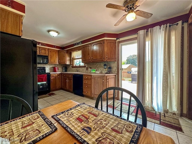 2308 Bears Den Rd, Youngstown, OH 44511 - kitchen featuring black appliances, light countertops, light tile patterned flooring, ceiling fan, and tasteful backsplash