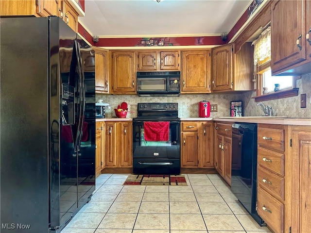 2308 Bears Den Rd, Youngstown, OH 44511 - kitchen with black appliances, light tile patterned floors, and brown cabinetry