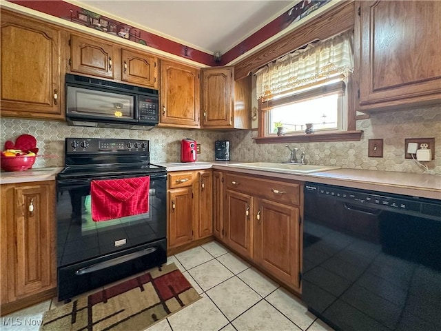 2308 Bears Den Rd, Youngstown, OH 44511 - kitchen with black appliances, a sink, brown cabinetry, and light countertops