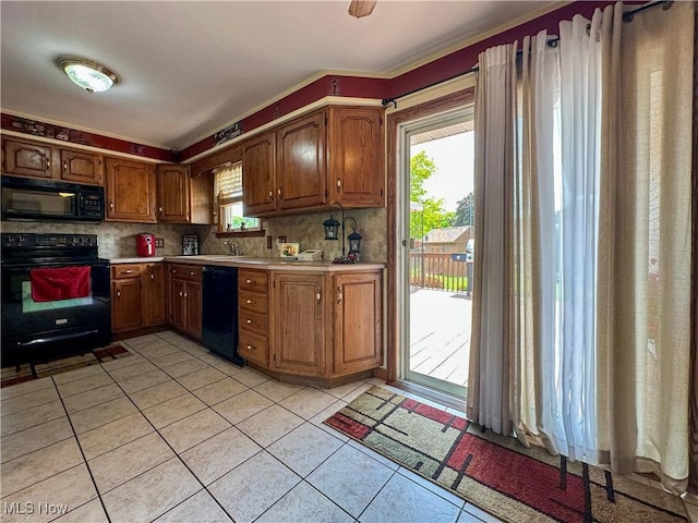 2308 Bears Den Rd, Youngstown, OH 44511 - kitchen featuring black appliances, light countertops, light tile patterned floors, and decorative backsplash