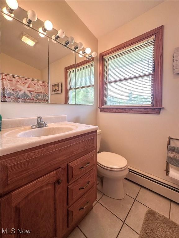 2308 Bears Den Rd, Youngstown, OH 44511 - full bathroom featuring tile patterned floors, vanity, toilet, and a baseboard radiator
