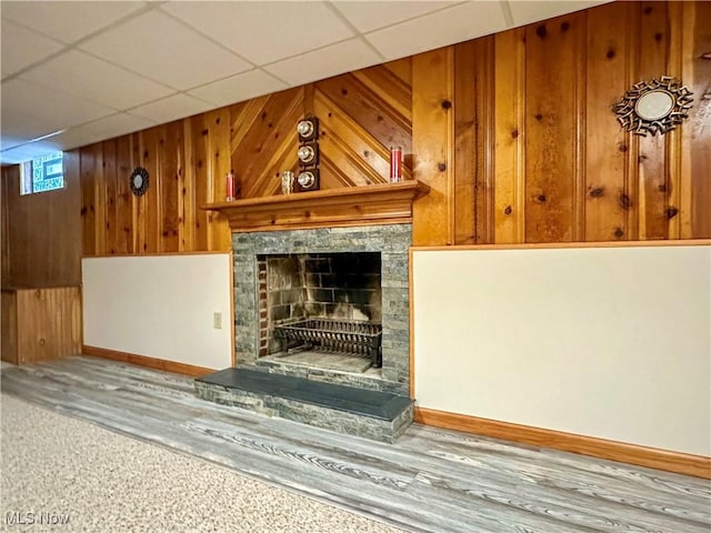 2308 Bears Den Rd, Youngstown, OH 44511 - unfurnished living room with wood walls, baseboards, and a fireplace with raised hearth
