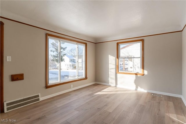 4827 E 88th St, Garfield Heights, OH 44125 - spare room featuring baseboards, light wood-style floors, and crown molding