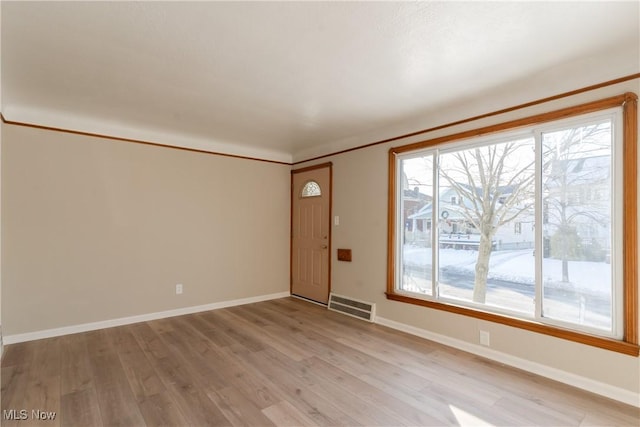 4827 E 88th St, Garfield Heights, OH 44125 - foyer entrance featuring baseboards and light wood finished floors