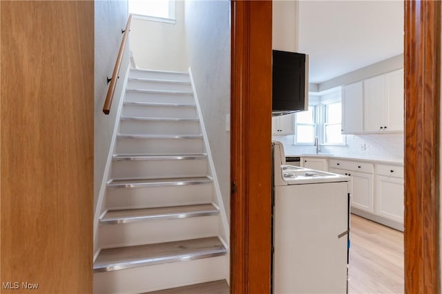 4827 E 88th St, Garfield Heights, OH 44125 - staircase featuring washer / dryer and wood finished floors