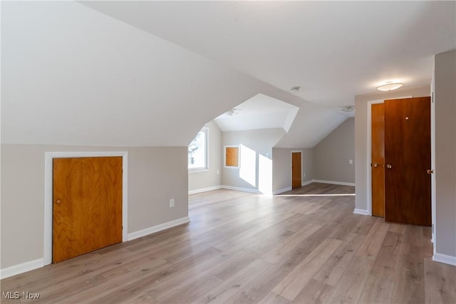 4827 E 88th St, Garfield Heights, OH 44125 - additional living space with light wood finished floors, baseboards, and vaulted ceiling