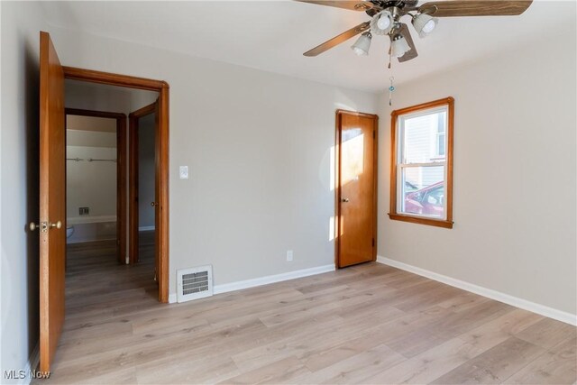 4827 E 88th St, Garfield Heights, OH 44125 - empty room with light wood-style floors, ceiling fan, and baseboards