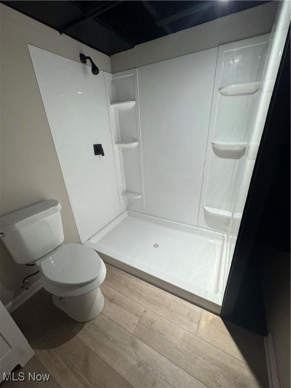 4827 E 88th St, Garfield Heights, OH 44125 - bathroom featuring wood finished floors, a shower stall, and toilet
