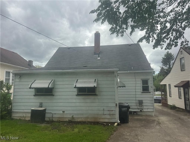 4827 E 88th St, Garfield Heights, OH 44125 - back of house with central AC unit and a chimney