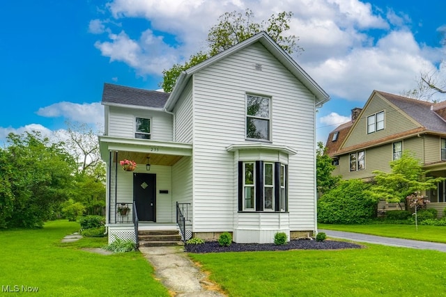 235 Elm St, Oberlin, OH 44074 - view of front of property with a front yard and a porch