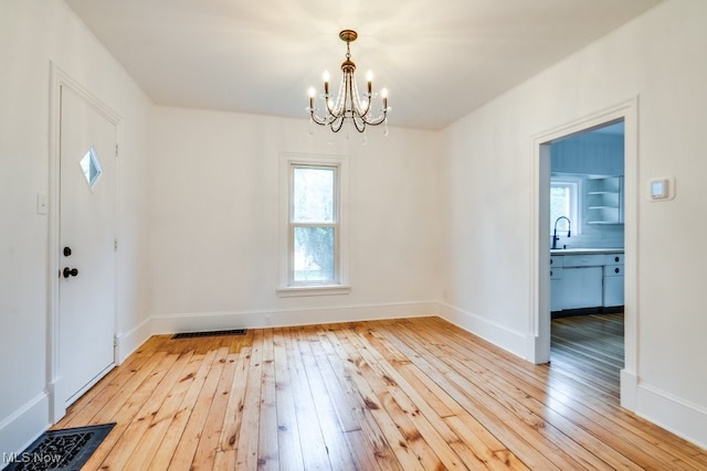 235 Elm St, Oberlin, OH 44074 - foyer entrance with a chandelier, light wood-type flooring, and baseboards