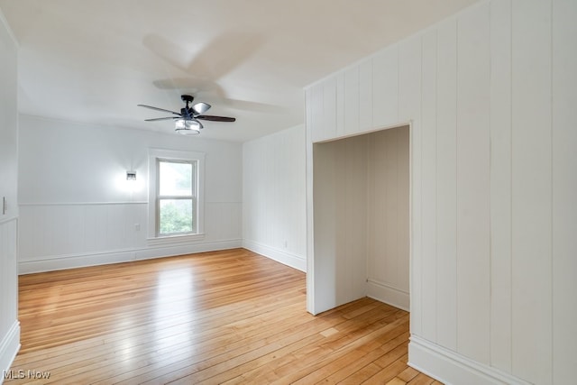 235 Elm St, Oberlin, OH 44074 - spare room with light wood finished floors, ceiling fan, and a decorative wall
