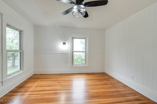 235 Elm St, Oberlin, OH 44074 - unfurnished room with light wood-style flooring, healthy amount of natural light, and a ceiling fan