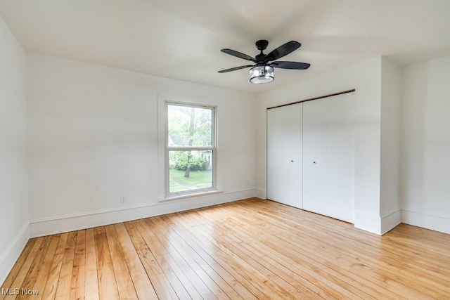 235 Elm St, Oberlin, OH 44074 - unfurnished bedroom with hardwood / wood-style flooring, a closet, a ceiling fan, and baseboards