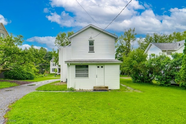 235 Elm St, Oberlin, OH 44074 - rear view of house with a yard