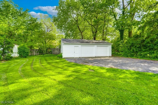 235 Elm St, Oberlin, OH 44074 - view of yard featuring an outdoor structure and a detached garage