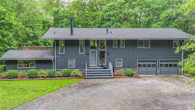 875 N Medina Line Rd, Akron, OH 44333 - split foyer home with gravel driveway, a garage, roof with shingles, and a front yard