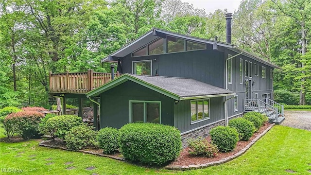 875 N Medina Line Rd, Akron, OH 44333 - view of property exterior featuring a lawn, roof with shingles, and a wooden deck
