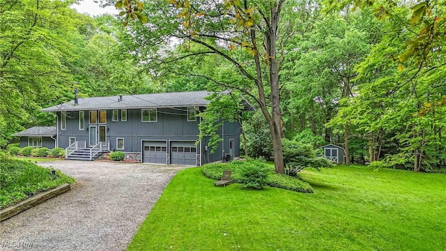 875 N Medina Line Rd, Akron, OH 44333 - split foyer home featuring driveway, board and batten siding, a front yard, a wooded view, and a garage