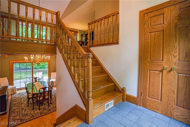 875 N Medina Line Rd, Akron, OH 44333 - staircase with a chandelier and baseboards