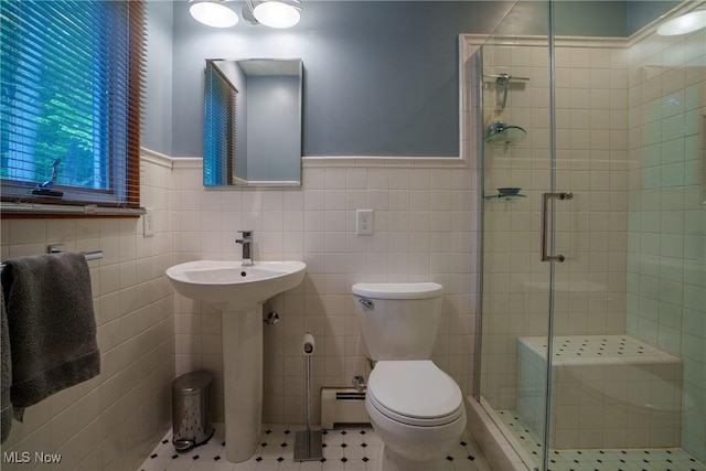 875 N Medina Line Rd, Akron, OH 44333 - bathroom with a stall shower, toilet, a wainscoted wall, a baseboard heating unit, and tile walls
