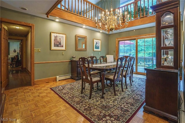 875 N Medina Line Rd, Akron, OH 44333 - dining area with a baseboard heating unit, baseboards, a chandelier, and a towering ceiling