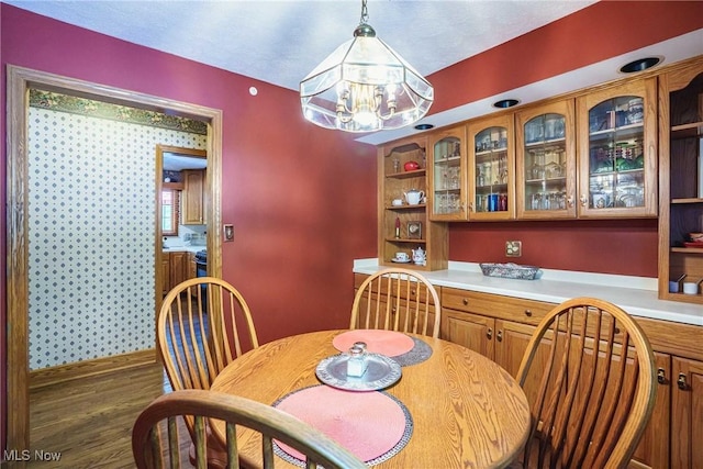 875 N Medina Line Rd, Akron, OH 44333 - dining room with a chandelier, wood finished floors, and baseboards