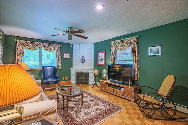 875 N Medina Line Rd, Akron, OH 44333 - living area featuring healthy amount of natural light, a textured ceiling, a ceiling fan, and a fireplace