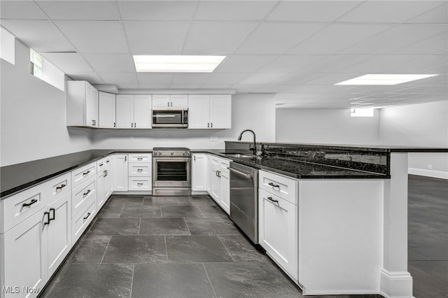 2344 Country Brook Dr, Hinckley, OH 44233 - kitchen featuring appliances with stainless steel finishes, a peninsula, a sink, white cabinets, and a drop ceiling