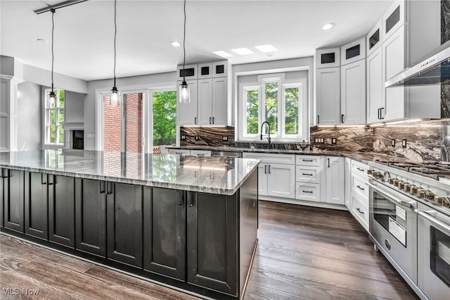 2344 Country Brook Dr, Hinckley, OH 44233 - kitchen with stainless steel appliances, a large island, a sink, dark stone countertops, and white cabinets