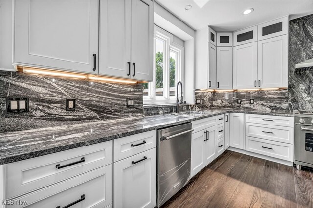 2344 Country Brook Dr, Hinckley, OH 44233 - kitchen with appliances with stainless steel finishes, dark stone counters, white cabinetry, tasteful backsplash, and recessed lighting