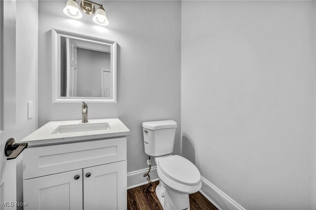 2344 Country Brook Dr, Hinckley, OH 44233 - bathroom featuring toilet, wood finished floors, vanity, and baseboards