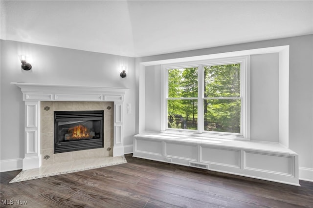 2344 Country Brook Dr, Hinckley, OH 44233 - unfurnished living room with dark wood-style floors, a tiled fireplace, and baseboards