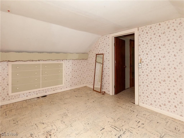 12209 Tinkers Creek Rd, Valley View, OH 44125 - additional living space with vaulted ceiling, baseboards, and wallpapered walls