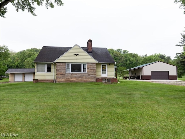 12209 Tinkers Creek Rd, Valley View, OH 44125 - view of front of property featuring a detached garage, a chimney, an outdoor structure, a front lawn, and stone siding