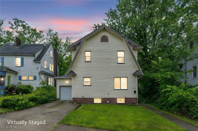 10234 Park Heights Rd, Cleveland, OH 44104 - dutch colonial featuring driveway, a front lawn, a gambrel roof, and a garage