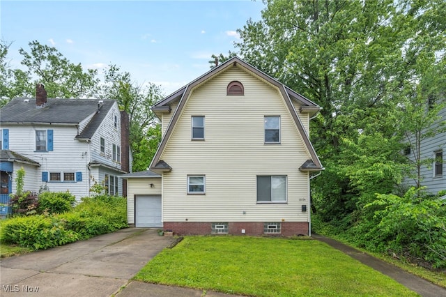 10234 Park Heights Rd, Cleveland, OH 44104 - view of front of house featuring a front yard, driveway, a gambrel roof, and a garage