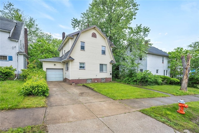 10234 Park Heights Rd, Cleveland, OH 44104 - view of front facade featuring a gambrel roof, a front lawn, concrete driveway, an attached garage, and a chimney