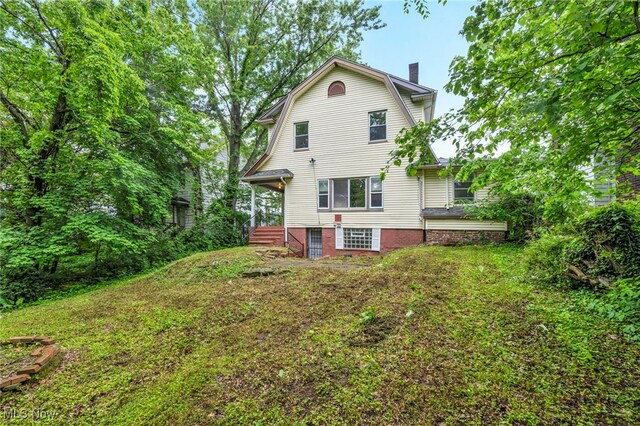 10234 Park Heights Rd, Cleveland, OH 44104 - back of house featuring a chimney and a gambrel roof