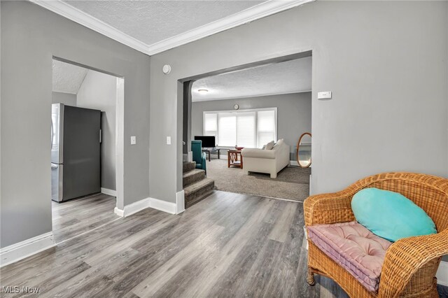 10234 Park Heights Rd, Cleveland, OH 44104 - corridor with a textured ceiling, wood finished floors, baseboards, and ornamental molding