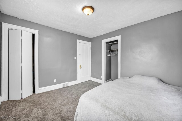 10234 Park Heights Rd, Cleveland, OH 44104 - carpeted bedroom with a textured ceiling and baseboards