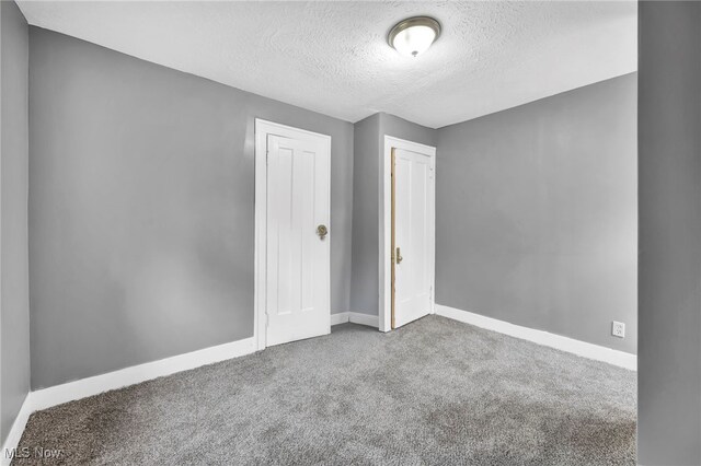 10234 Park Heights Rd, Cleveland, OH 44104 - unfurnished room featuring a textured ceiling, carpet flooring, and baseboards