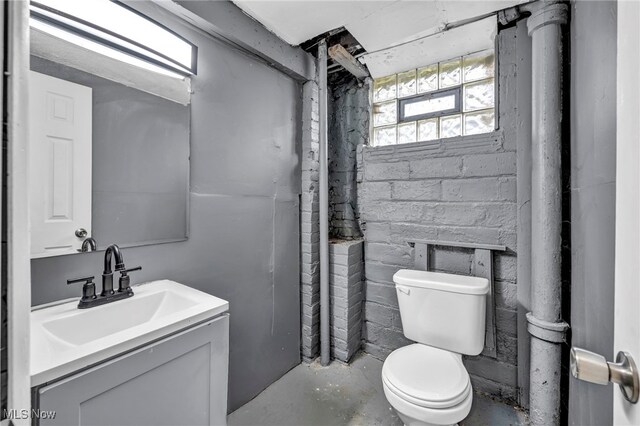 10234 Park Heights Rd, Cleveland, OH 44104 - bathroom with unfinished concrete floors, toilet, and vanity