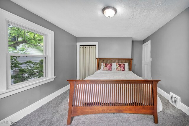 10234 Park Heights Rd, Cleveland, OH 44104 - carpeted bedroom featuring baseboards and a textured ceiling