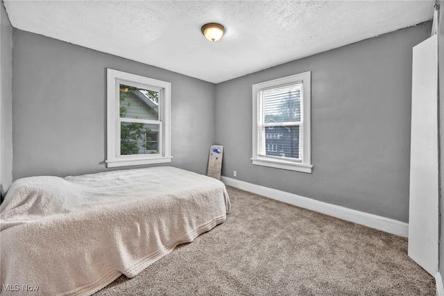 10234 Park Heights Rd, Cleveland, OH 44104 - carpeted bedroom featuring baseboards and a textured ceiling