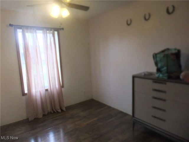 10677 Moss Rd, Lodi, OH 44254 - unfurnished bedroom with dark wood-type flooring and ceiling fan
