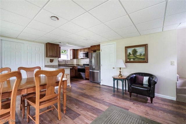 32094 Woodale Dr, Hanoverton, OH 44423 - dining room featuring dark wood finished floors, baseboards, and a drop ceiling