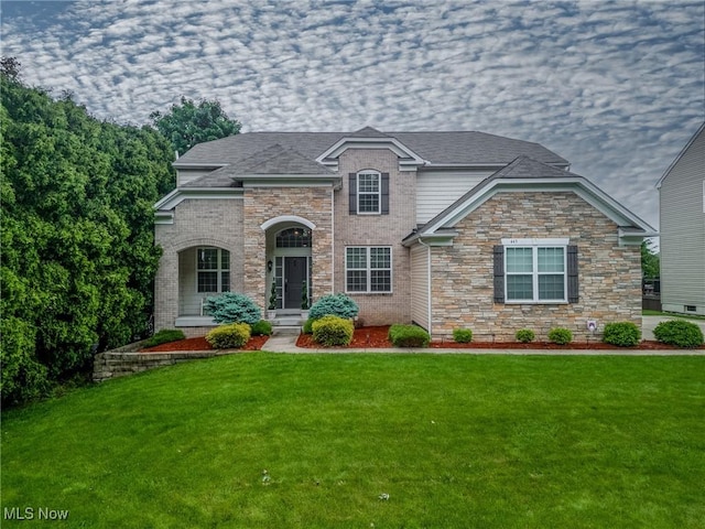 443 S Hametown Rd, Copley, OH 44321 - view of front of home with a front yard, stone siding, and brick siding
