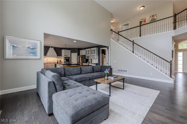 443 S Hametown Rd, Copley, OH 44321 - living area with a towering ceiling, baseboards, dark wood-style floors, and stairs