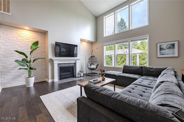 443 S Hametown Rd, Copley, OH 44321 - living area featuring high vaulted ceiling, baseboards, healthy amount of natural light, dark wood-style flooring, and a glass covered fireplace